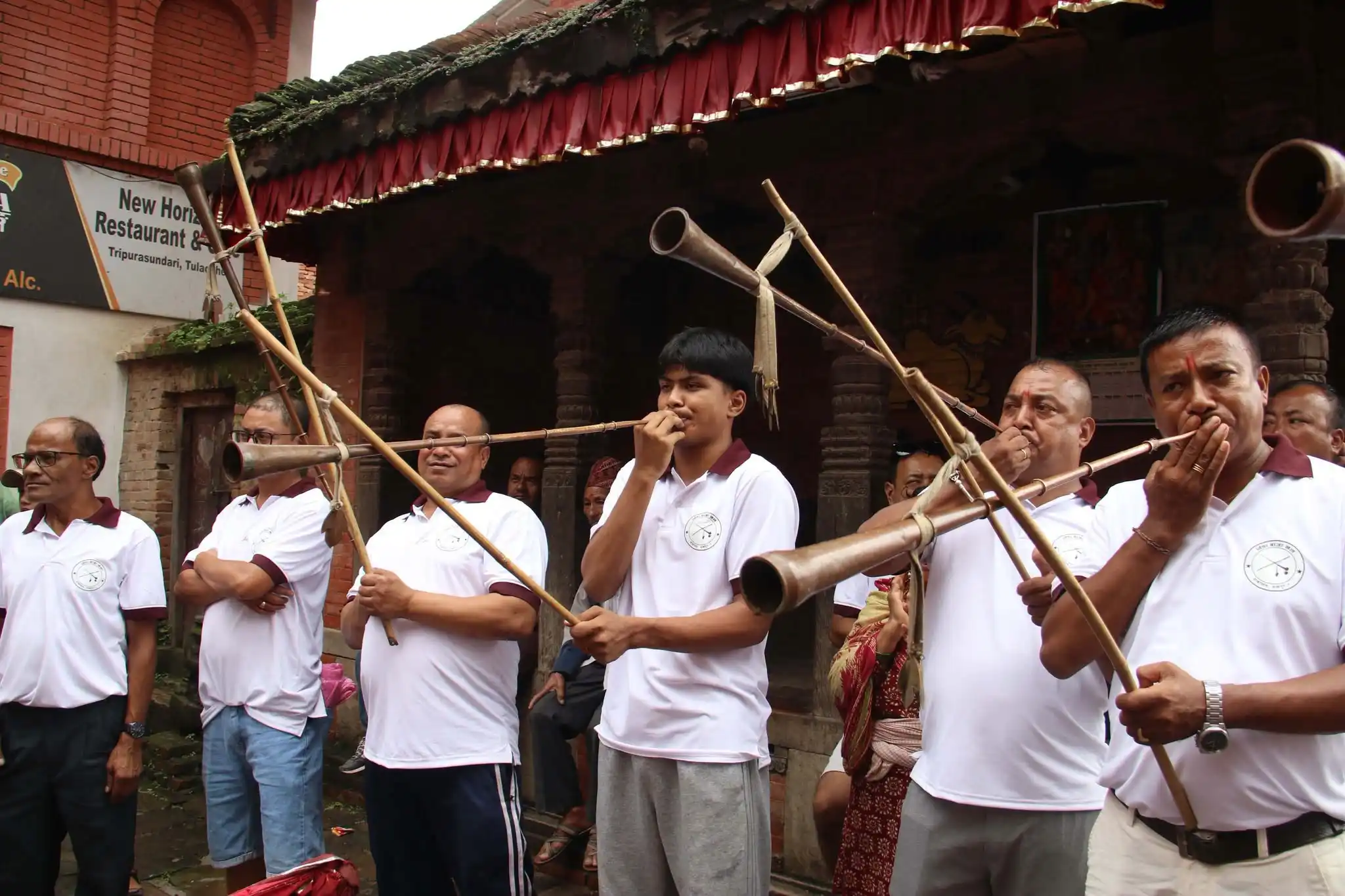 Blewing Pong (musical instrumental) during offering Panjaran Dan to Dipankar Buddha.
